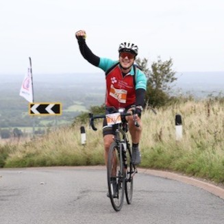 Adam celebrating on his bike