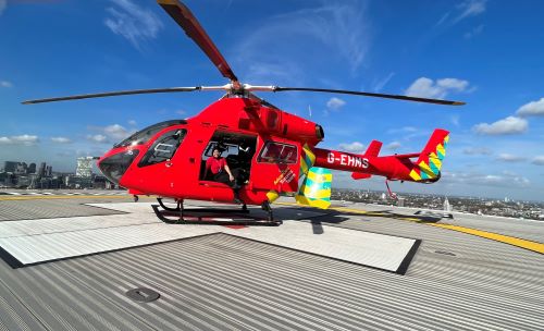 Aisha, London's Air Ambulance's Ambulance Clinician, in front of the helicopter