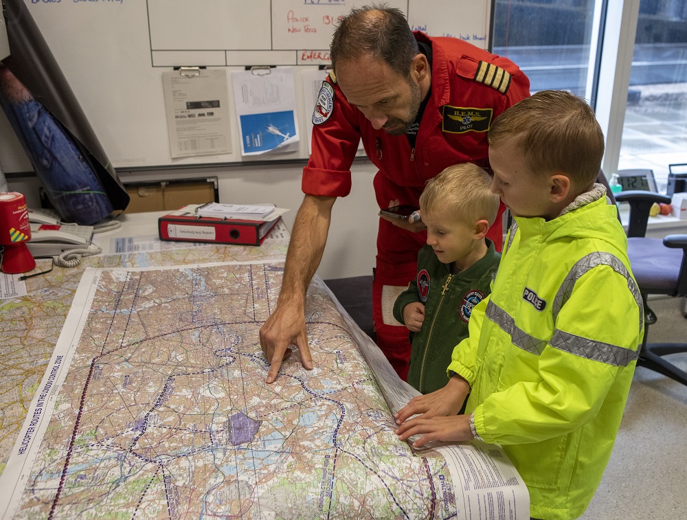Chief Pilot showing Catherine's sons around the helipad