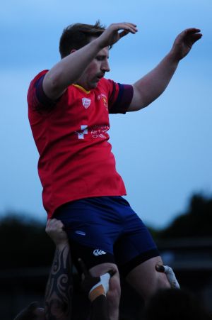 Man playing rugby in a London's Air Ambulance Charity branded jersey