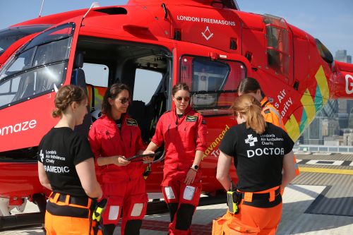 All female crew doing a check outside the helicopter