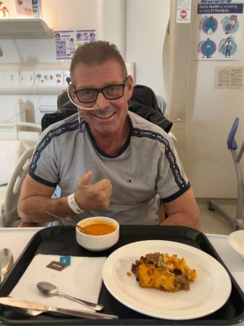 Mike eating his first proper meal since the accident