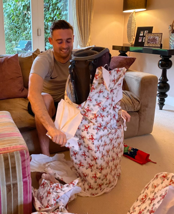 George opening a present at Christmas