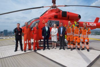 Group of people on The Royal London Hospital helipad to celebrate opening of new helipad space
