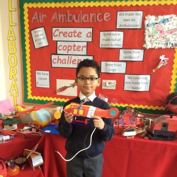 Pupil holding his London's Air Ambulance helicopter model