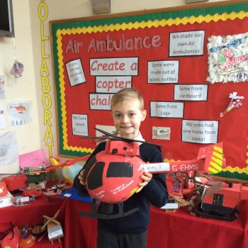 Pupil holding his London's Air Ambulance helicopter model