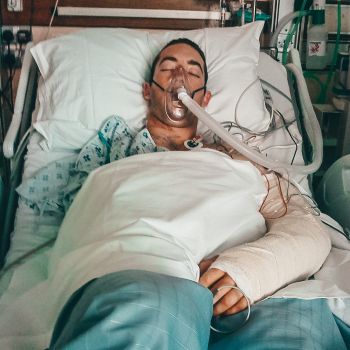 Dan in hospital, with one arm