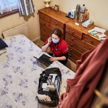 PRU doctor working in someone's bedroom