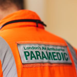 Man wearing orange flight suit, with paramedic written on the back