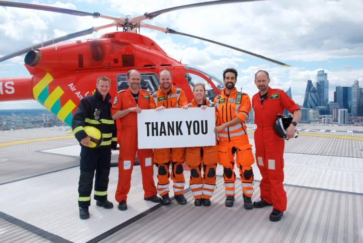 Crew holding thank you card