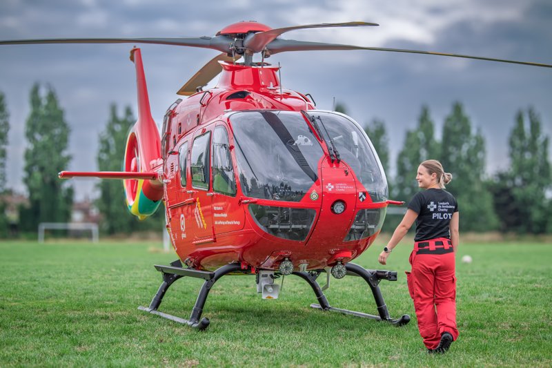 Pilot Adele with helicopter in a field