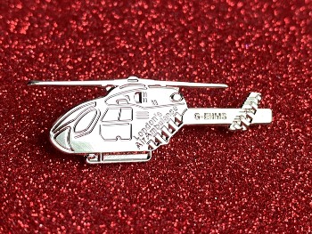 Helicopter pin badge of red background
