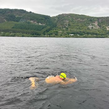 One swimmer swimming his relay in Loch Ness for London's Air Ambulance Charity