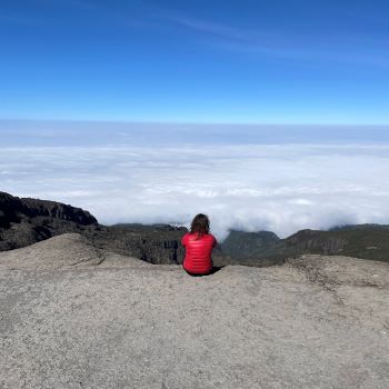 Sue sat at the top of Mount Kilimanjaro, after climbing it for London's Air Ambulance Charity