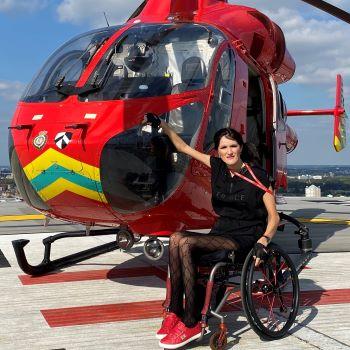 Vaiva in her wheelchair on the helipad next to our helicopter