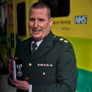 Jason Morris receiving Queen's Ambulance Medal