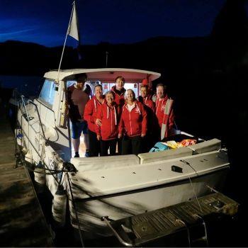 Donald Clan family on a boat before starting their Loch Ness relay swim for London's Air Ambulance Charity