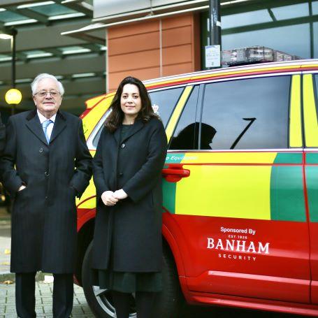 Banham Security board members standing by London's Air Ambulance Charity's rapid response car