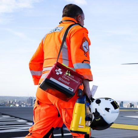 Medic carrying blood to the helicopter
