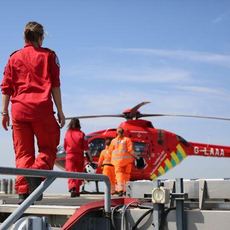 All female crew walking to the helicopter on the helipad