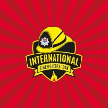 Icon of a firefighter's helmet, with International Firefighters' Day written on a badge